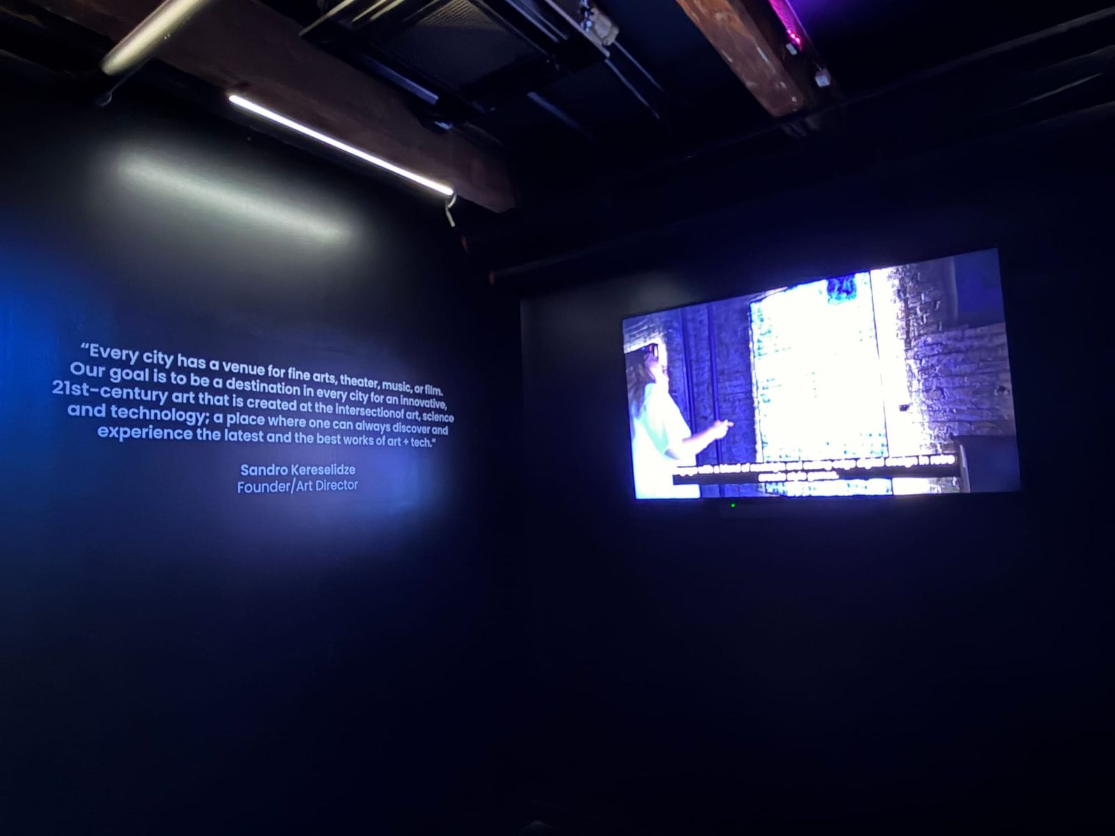 Sandro Kereselidze's founder quote projected on the wall alongside a video screen showing him speaking inside the ARTECHOUSE space